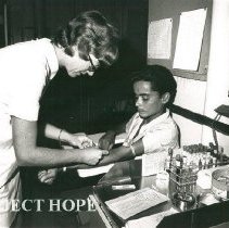 Susan Willson, Medical Technologist, drawing blood from a Brazilian patient